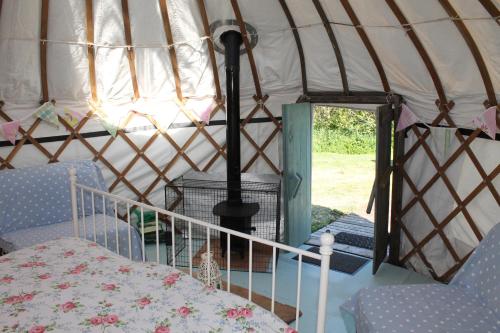 a room with a bed in a yurt at Mill Haven Place glamping yurt 3 in Haverfordwest