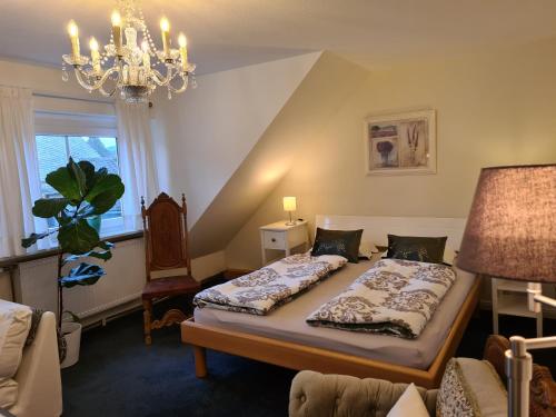 a bedroom with a bed and a chandelier at freundliche Unterkunft Sauerland in Meschede