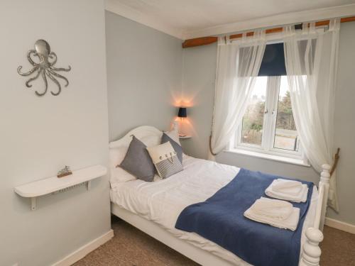 a small bedroom with a bed and a window at Mulgrave Cottage in Saltburn-by-the-Sea