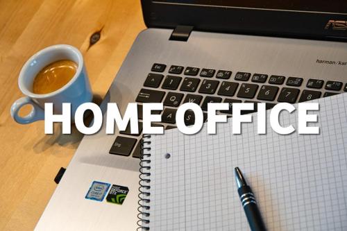 a laptop computer with the words home office next to a cup of coffee at Gemütliche Ferienwohnung Bergwiese, 2-Raum, separates Schlafzimmer, schönen Balkon oder Terrasse, Komfort Ausstattung, ruhige Südlage, kostenfrei WLAN und schöne helle Sauna, Brötchenservice, Parkplatz, Hunde auf Anfrage, E-Tankstelle, Sonnenlage in Balderschwang
