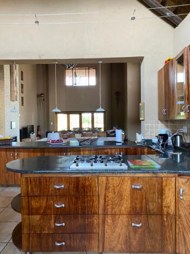 a large kitchen with a stove top island in it at Luna rossa 19 Zebula golf course and spa resort in Mabula