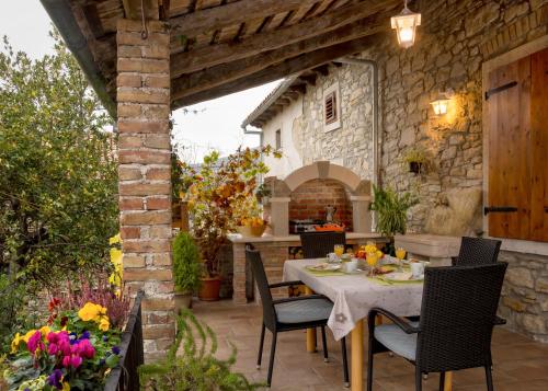 an outdoor dining area with a table and chairs at Apartments Roža in Roč