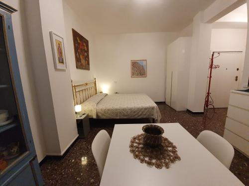 a room with two beds and a table and chairs at Monolocale Vittoria in Pesaro