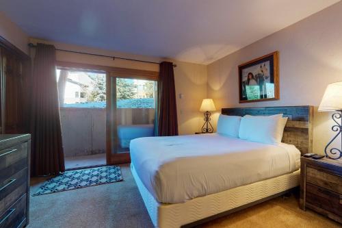 a bedroom with a large bed and a window at Phoenix I in Steamboat Springs