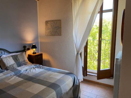 a bedroom with a bed and a large window at Podere La Tona in Gavorrano