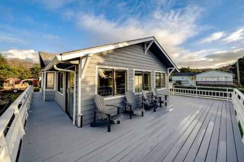 a large deck with chairs on a house at The Chinook House in Depoe Bay