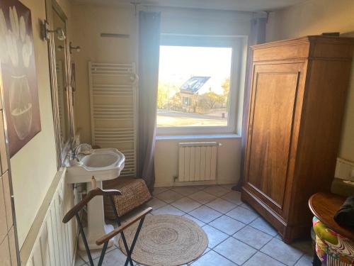 a small bathroom with a sink and a window at @KDO SWEET HOME in Richemont