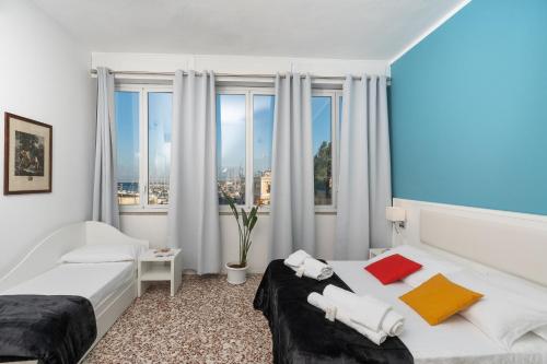 a hotel room with a bed and a window at Regina Margherita - Bed and Breakfast & Rooftop Lounge Bar in Siracusa