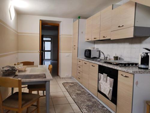 a kitchen with a table and a stove top oven at Borgo Antico in Portocannone