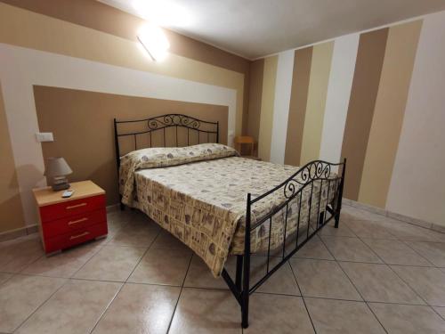 a bedroom with a bed and a dresser with a night stand at Borgo Antico in Portocannone