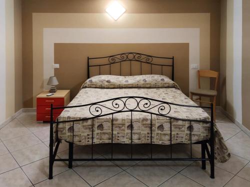 a bedroom with a bed with a wrought iron bed frame at Borgo Antico in Portocannone