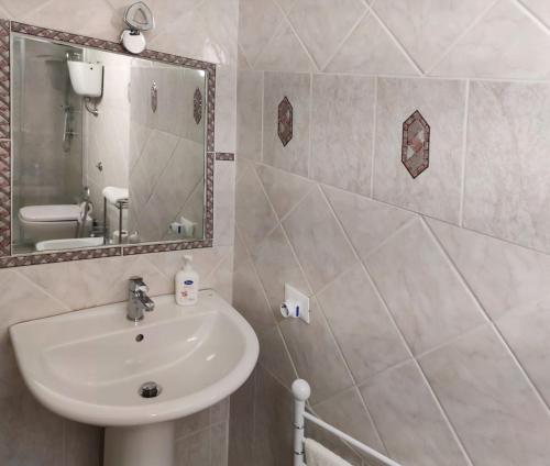 a bathroom with a sink and a mirror at Borgo Antico in Portocannone