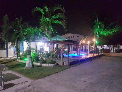 a house with a swimming pool at night at Pousada Luar in Santa Cruz Cabrália