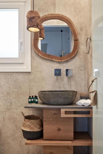 a bathroom with a sink and a mirror at Volcano Luxury Suites Milos - Adults Only in Paliochori