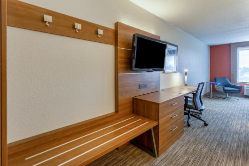 a room with a desk and a flat screen tv at Holiday Inn Express & Suites O'Fallon-Shiloh by IHG in Shiloh