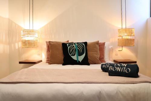 a bed with two pillows on it in a bedroom at Residencia Tropical Don Bonito in Sayulita