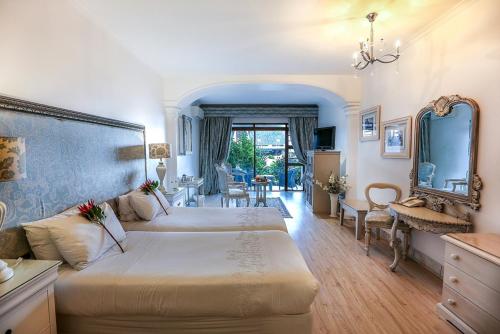 a bedroom with two beds and a mirror at Misty Waves Boutique Hotel in Hermanus