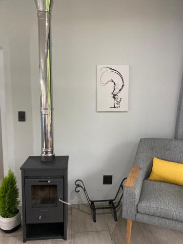 a living room with a couch and a fireplace at Kingsbrook Pods in Clarens