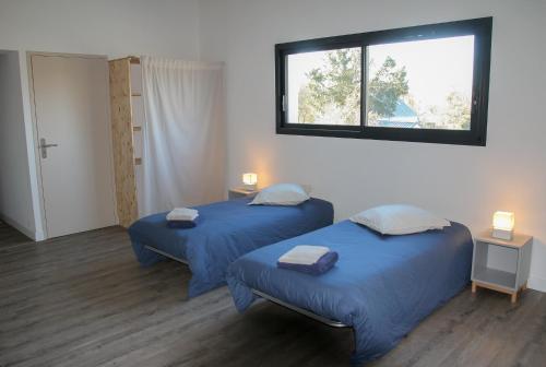 Ένα ή περισσότερα κρεβάτια σε δωμάτιο στο Chambres d'étape - Le Répit de l'Oust - Certifié Ecolabel Européen