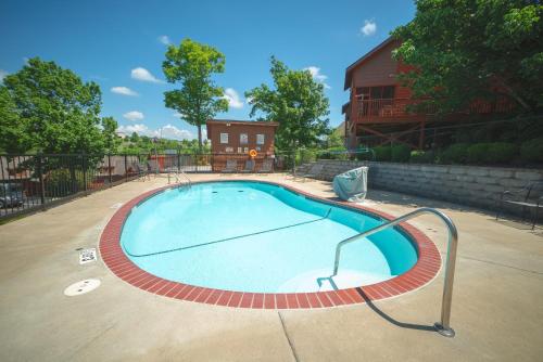 a large swimming pool in a yard at Cabins at Grand Mountain in Branson