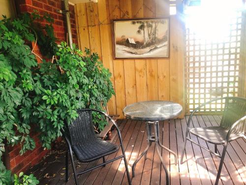 a patio with chairs and a table and a plant at Golden House in Springvale