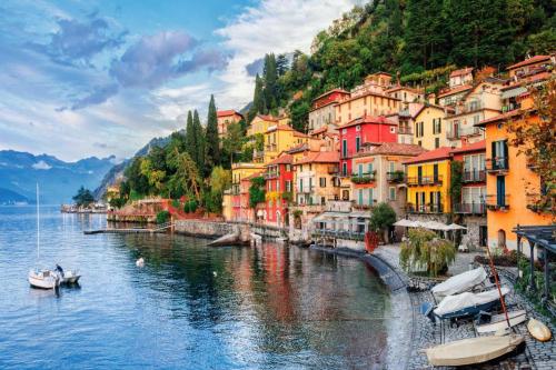 a group of buildings on the side of a river at Villa Silvana in Perledo