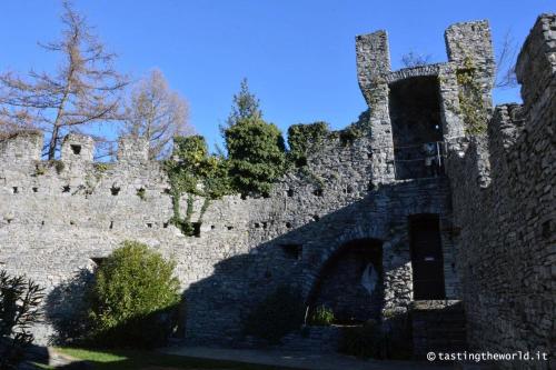 an old stone building with trees on top of it at Villa Silvana in Perledo