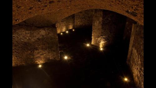 a stone tunnel with lights in the dark at Villa Silvana in Perledo