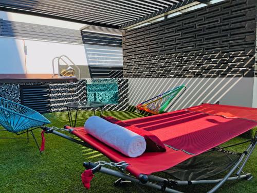 a red folding table and chairs in a room at Cadillac Hotel Boutique in Mexico City