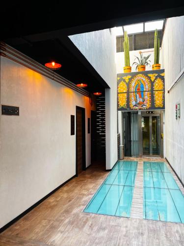 a swimming pool in a building with a tile floor at Cadillac Hotel Boutique in Mexico City