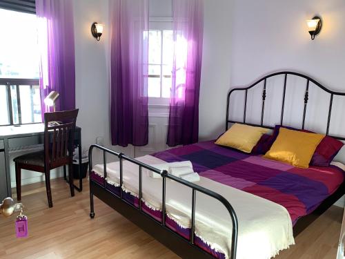 a bedroom with a bed with purple curtains and a chair at Chambres EL MEDITERRANEO Rooms in Montréal