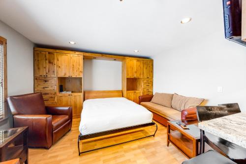 a living room with a bed and a couch at Chateau Studio in Breckenridge