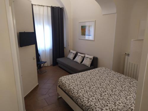 カーヴァ・デ・ティッレーニにあるCasaCriの小さなベッドルーム(ベッド1台、ソファ付)