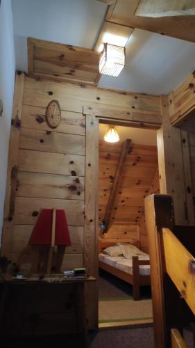 a room with a bed and a clock on a wall at Apartments Life in Kolašin
