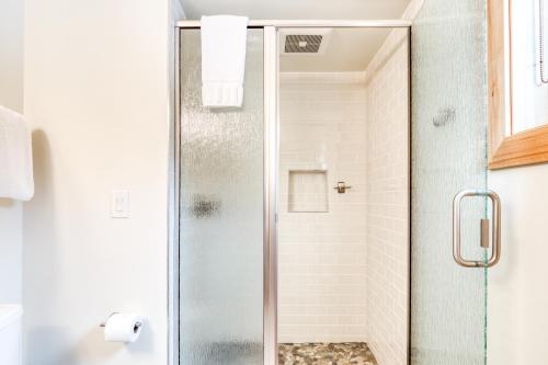 a shower with a glass door in a bathroom at Golden Poles Chalet #110 in Government Camp