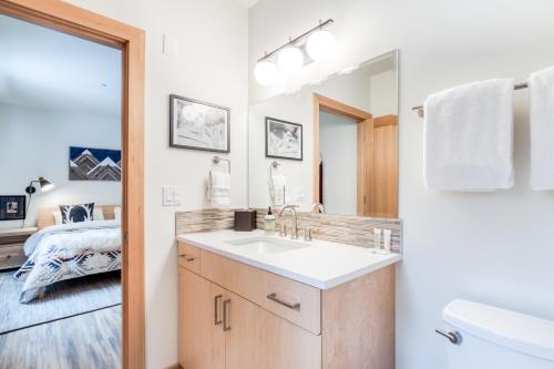 a bathroom with a sink and a toilet and a bed at Golden Poles Chalet #110 in Government Camp