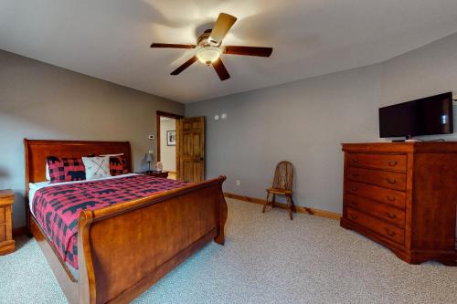 a bedroom with a bed and a ceiling fan at Thunder Ridge Lodge in Newry