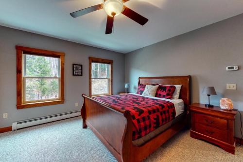 a bedroom with a bed and a ceiling fan at Thunder Ridge Lodge in Newry
