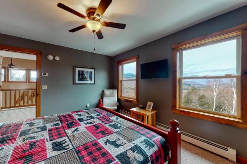 a bedroom with a bed and a ceiling fan at Thunder Ridge Lodge in Newry