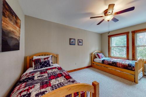 a bedroom with two beds and a ceiling fan at Thunder Ridge Lodge in Newry