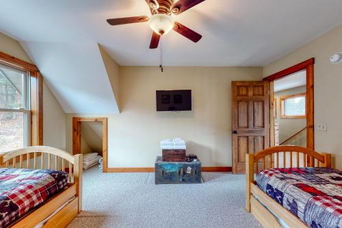 a bedroom with two beds and a ceiling fan at Thunder Ridge Lodge in Newry
