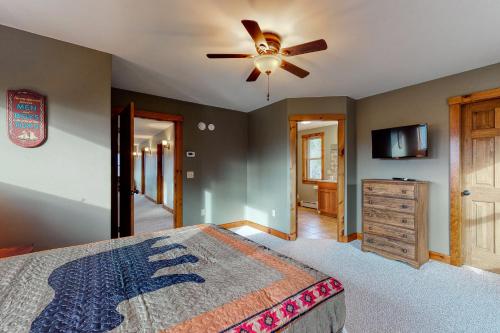 a bedroom with a bed and a ceiling fan at Thunder Ridge Lodge in Newry