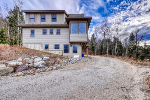 a house on a hill with a dirt road at Thunder Ridge Lodge in Newry