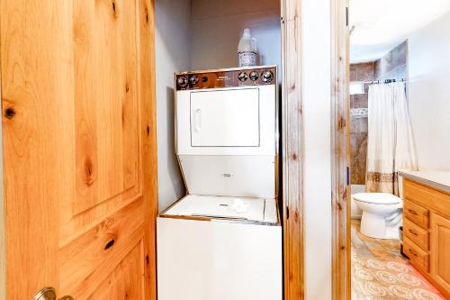 a small kitchen with a refrigerator and a toilet at Wildernest in Stateline