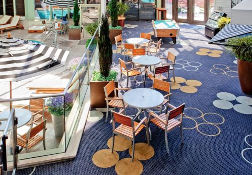 a restaurant with tables and chairs on a blue carpeted floor at Weber's Hotel & Restaurant in Ann Arbor
