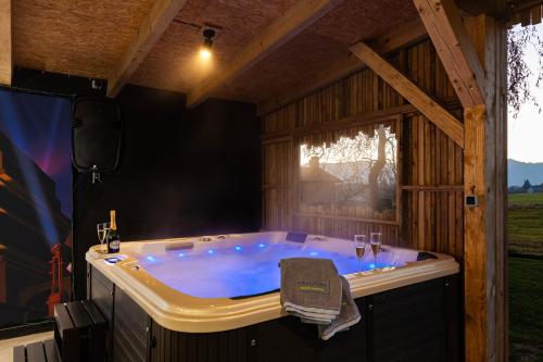 a jacuzzi tub in a room with a stage at Chaloupka V poli in Frýdlant nad Ostravicí