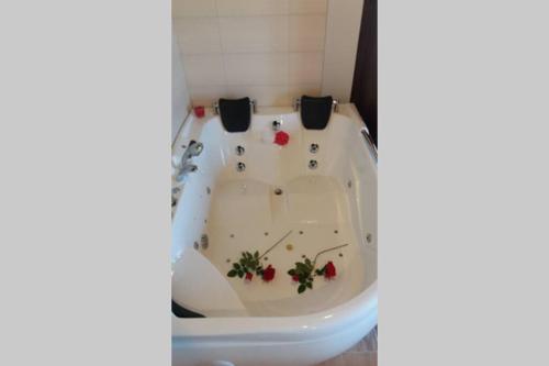 a bathroom with a bath tub with flowers on it at Lagar I con JACUZZI in Curiel de Duero