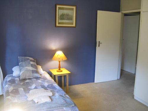a bedroom with a bed and a lamp on a table at Seven Falls Lodge in Kloof