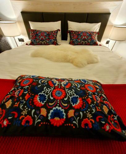 a large bed with a blanket with a flower pattern at Villa Olimpijska 2 - Centrum in Wisła