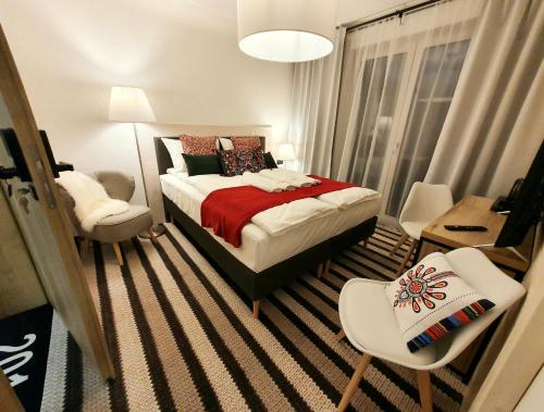 a small bedroom with a bed and a chair at Villa Olimpijska 2 - Centrum in Wisła